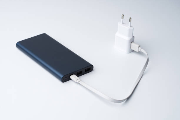 istock White USB power adapter, cable and blue power bank for divice isolated on a white background. 1218065194
