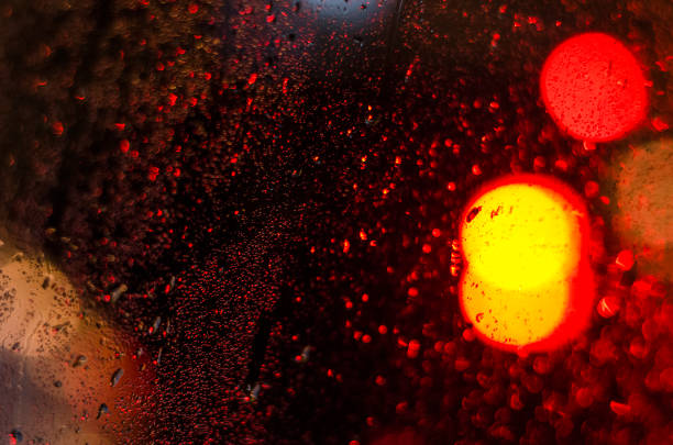 istock Raindrops on the glass window at night 1218067780
