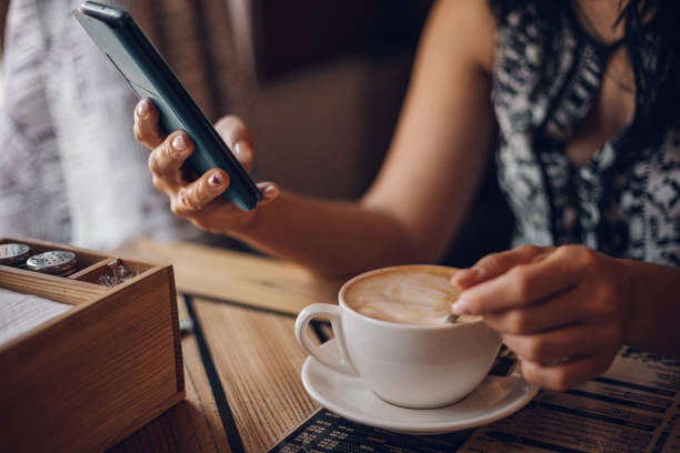istock Girl in a cafe drinks cappuccino 1218069033