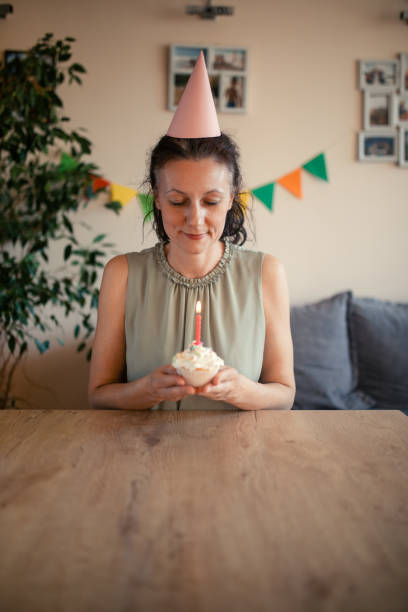 istock Woman celebrating birthday alone at home 1218071075