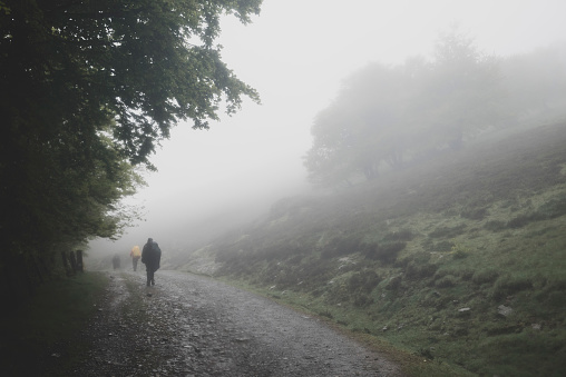 Pilgrims walk through mist on the Camino de Santiago, between the French border and the Spanish town of Roncesvalles.