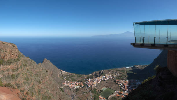 La Gomera - Skywalk at Mirador de Abrante with view to Agulo La Gomera - Skywalk at Mirador de Abrante with view to Agulo, on the horizon the island of Tenerife with mountain Teide agulo stock pictures, royalty-free photos & images