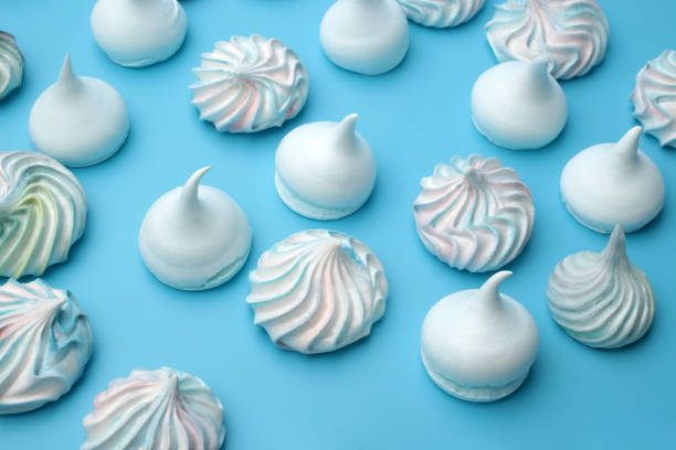 istock Colorful meringue cookies on blue background 1218074543