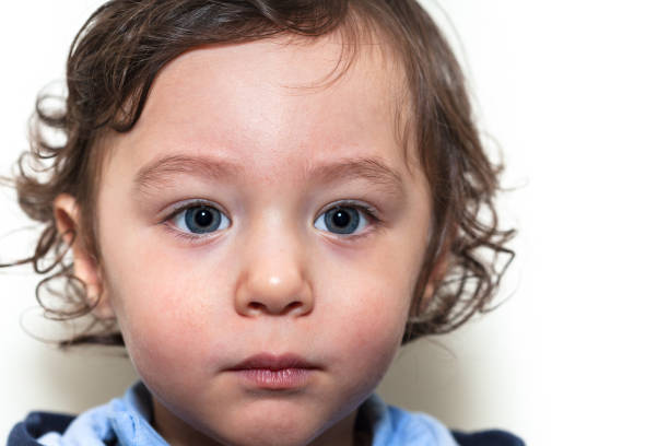 istock Blue eyed toddler up close looking away 1218074679