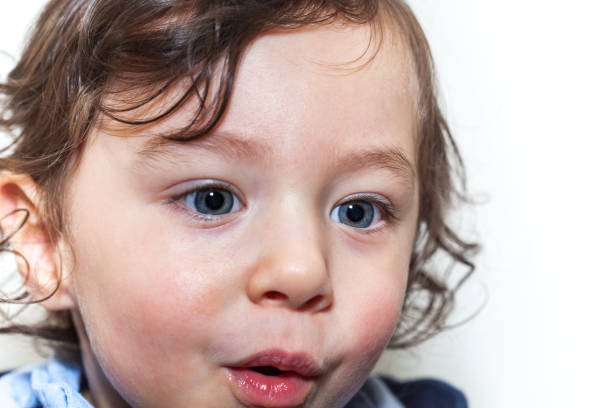 istock Blue eyed toddler up close looking away 1218074717