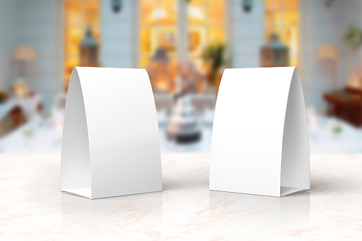 Blank paper menu table tents stands mockup on a marble stage or showroom for designers presentation, promotions etc.