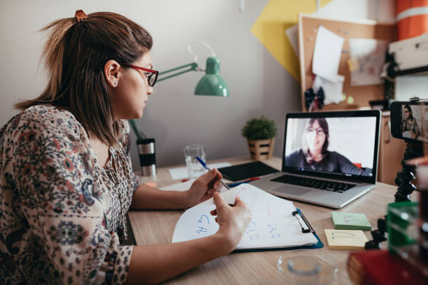 istock Professor and student discussing topics over online class platform 1218076467