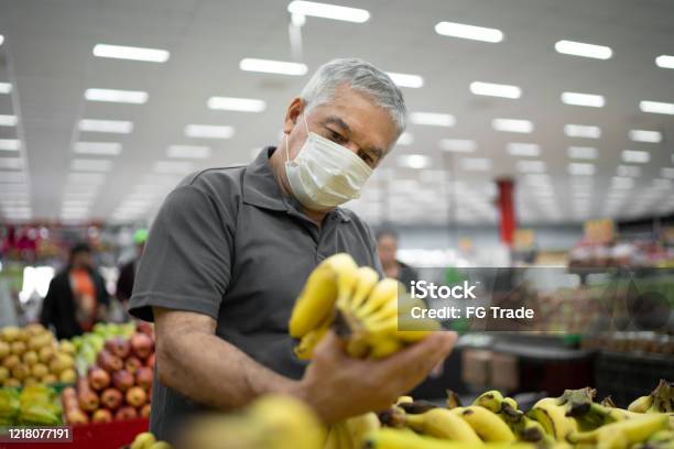 Senior Man With Disposable Medical Mask Shopping In Supermarket Stock Photo - Download Image Now