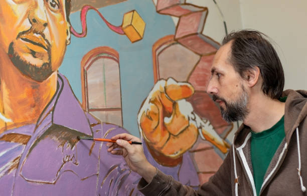 istock Painter at work. 3D art painting on the wall. 1218078425