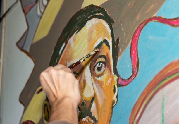 Painter at work. Close up of a hand holding the paint brush.