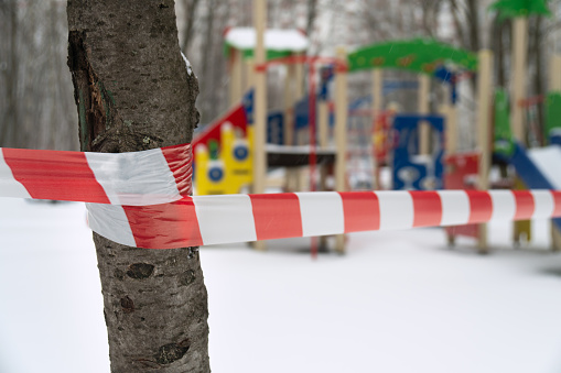 Closed children playground blocked by a barrier tape during a quarantine in Moscow