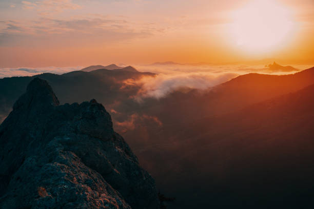 istock Sunset in the mountains in the fog 1218079823