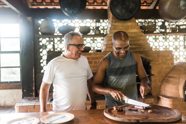 Smiling men at Brazilian barbecue Barbecue, father, son, father's day, love, father's day, meat brazilian bbq stock pictures, royalty-free photos & images