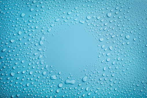 Water drops circle frame on blue background
