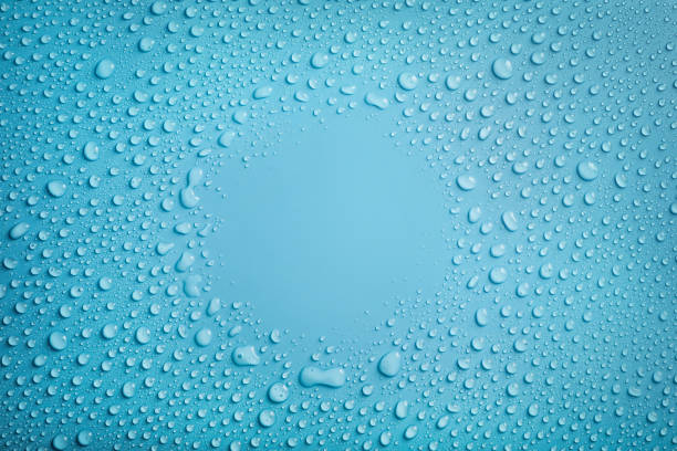 Water drops circle frame on blue background Circle frame of water drops on blue background. Copy space dew stock pictures, royalty-free photos & images