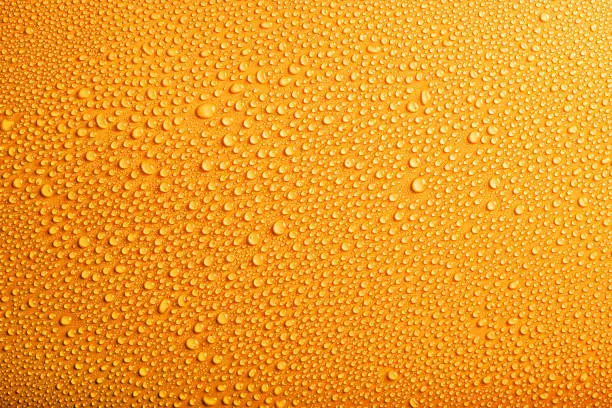 Photo of Water drops pattern on yellow background