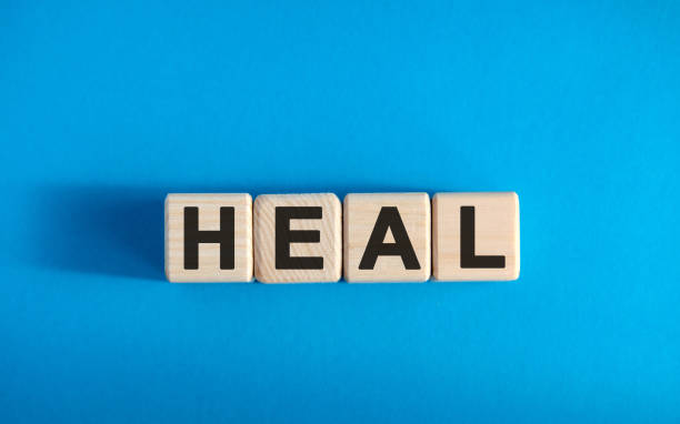 istock HEAL - text on wooden blocks, medical concept, blue background 1218082060