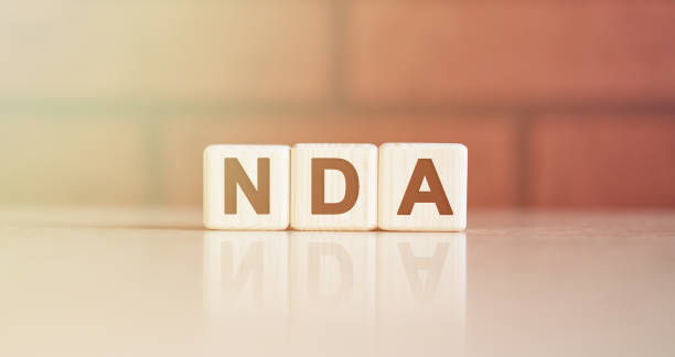 istock NDA acronym concept. Text on wooden cubes with bright light 1218082061