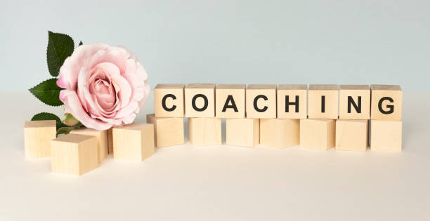 istock Coaching Word In Wooden Cube on a light background 1218082415