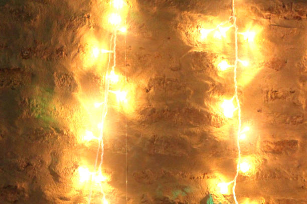 istock GIRNALDA OF WARM LIGHTS HANGING FROM THE BRICK WALL 1218084476