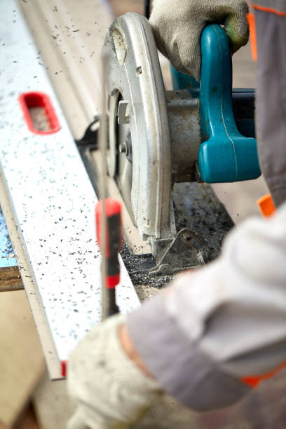 istock A construction contractor worker using a worm-driven hand-held circular saw to cut boards and plastic. Construction concept, own workshop, hiring a working contract for cutting wood 1218085057