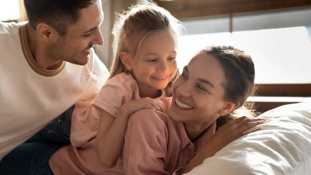 istock Young man having fun with mixed race wife and daughter. 1218085213