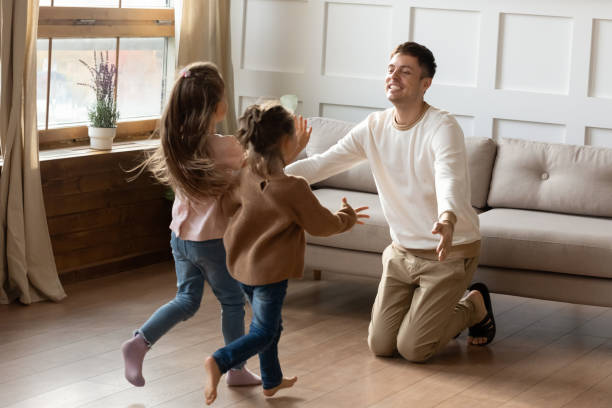 istock Cheerful young daddy ready to cuddle children. 1218085229