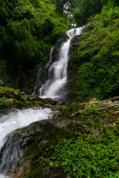 a beautiful waterfall in the lap of mountain