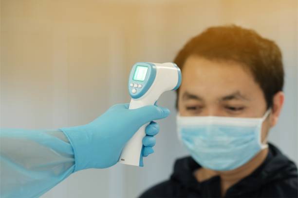 istock Medical staff use infrared forehead thermometer for check body temperature, Covid-19 outbreak concept 1218087582
