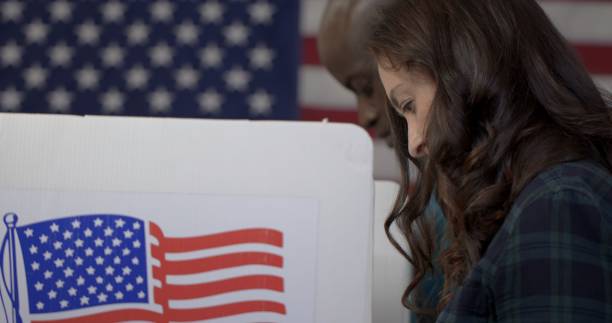 istock Side view woman voting, part hidden by long hair 1218087634