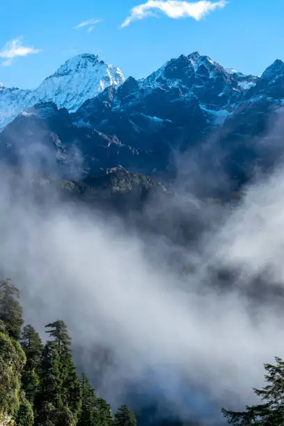 a beautiful mountain view with fog and clouds
