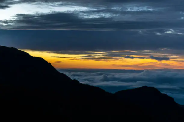 a beautiful mountain view with sunrise and clouds