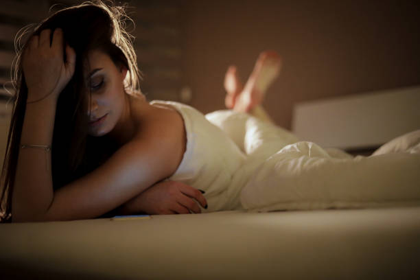 istock A woman in bed covered in a quilt 1218088642