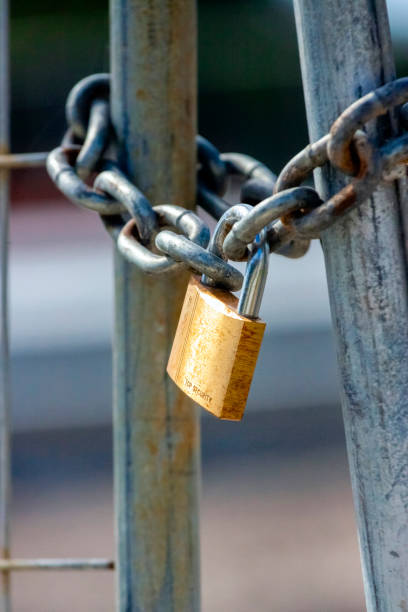 istock Closed gate with metal chain and padlock,  background with copy space 1218088648