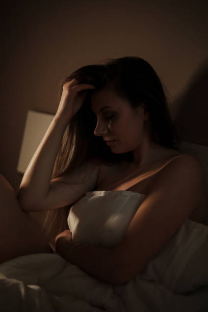 istock A woman in bed covered in a quilt 1218088725