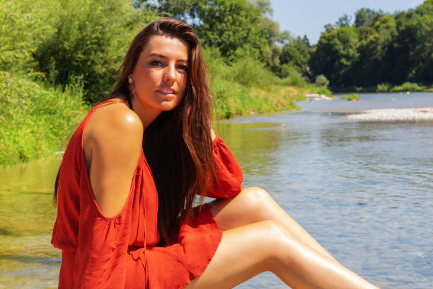 a young woman is having fun on the isar river in munich