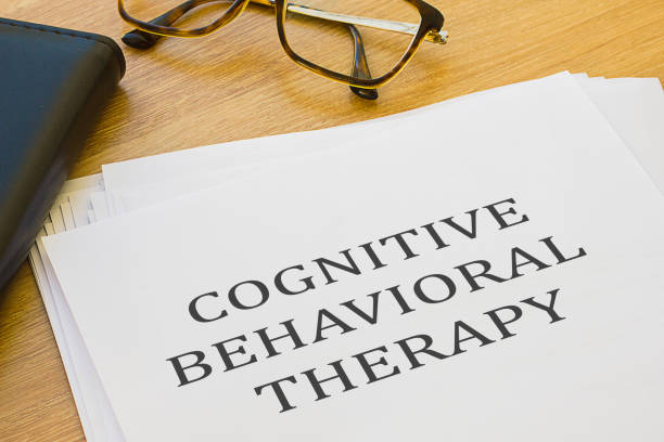 cognitive behavioral therapy - written on of white paper - behavioral problems imagens e fotografias de stock