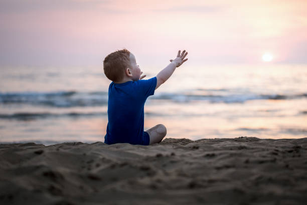 Lonely baby boy at the beach