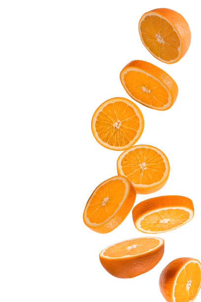 istock Flying fruits. Falling sliced orange fruit isolated on white background. 1218090999