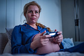 Pregnant woman playing PS4.
