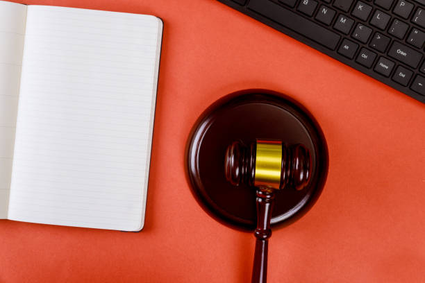 istock Workplace with notepad and keyboard judges wooden gavel 1218097691