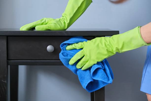 istock Cleaning service, close-up of gloved hands with microfiber cloth wiping dust 1218098600