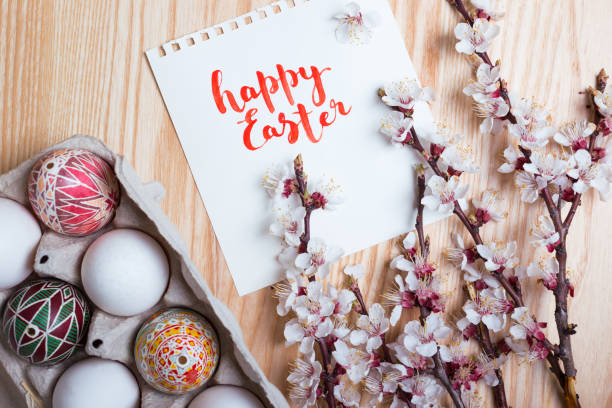 istock happy easter card. Box with   beautiful Easter eggs Pysanka handmade and sprigs of blossoming apricot on a wooden background  