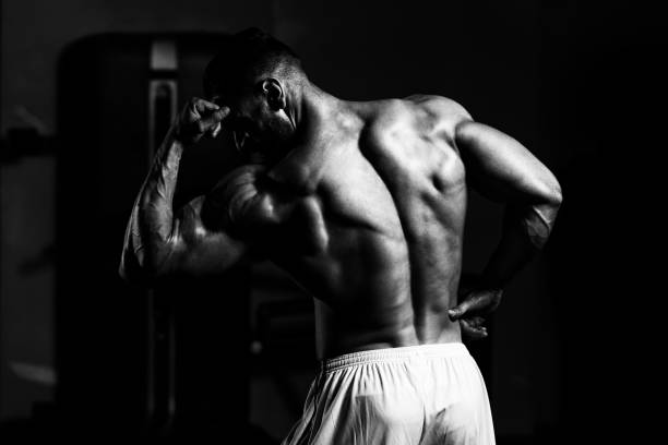 istock Handsome Muscular Man Flexing Muscles In Gym 1218104115