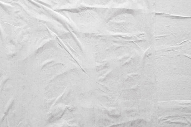 istock Blank white crumpled and creased paper poster texture background 1218104154