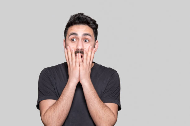 istock Portrait of shocked young man over grey background 1218105705