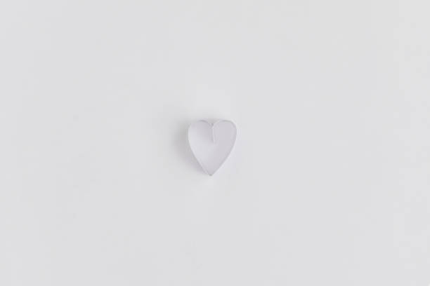 istock One heart made with knotted paper strip on white paper backdrop 1218105752
