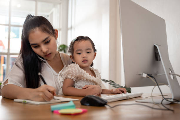istock Work from home concept. Mother and daughter using a computer and internet during mother working from home 1218109130