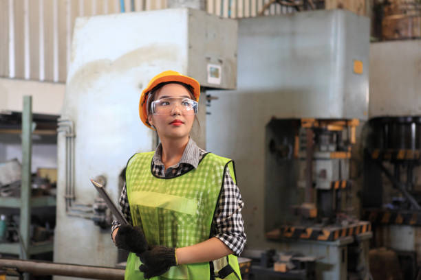 istock Female Industrial Engineers with  machine. Assist production engineer in industry. He checking or push metalwork control in industrial In a plastic factory for car. Concept Successful Of Work. 1218111748