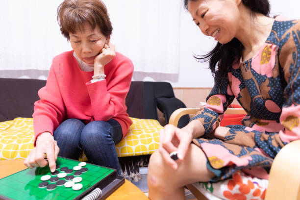 istock Mother and daughter playing board game 1218112707
